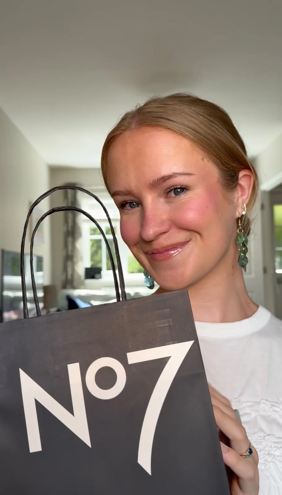 Me holding a No7 bag outside Boots